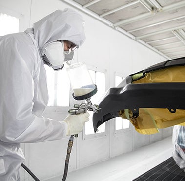 Collision Center Technician Painting a Vehicle | Fordham Toyota in Bronx NY